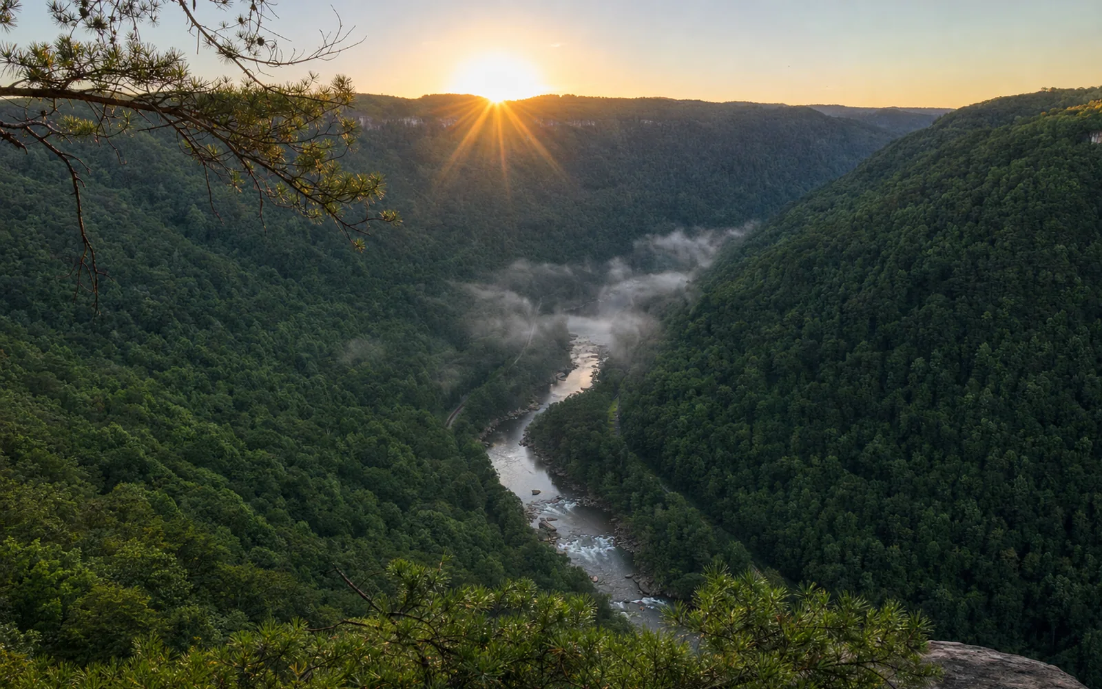 Sunrise from Diamond Point, the sun cresting the far rim and fog lying along the New River deep in the gorge, AI-generated illustration