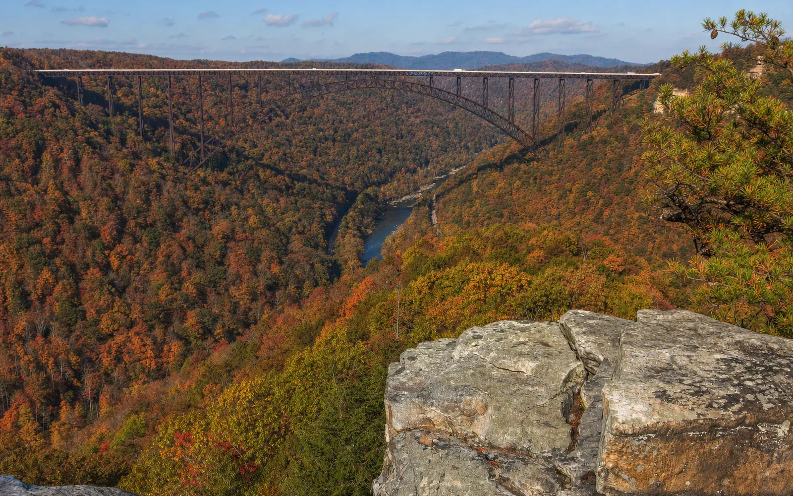The New River Gorge Bridge seen straight on from the Long Point overlook, its full arch and deck spanning the gorge above the river, AI-generated illustration