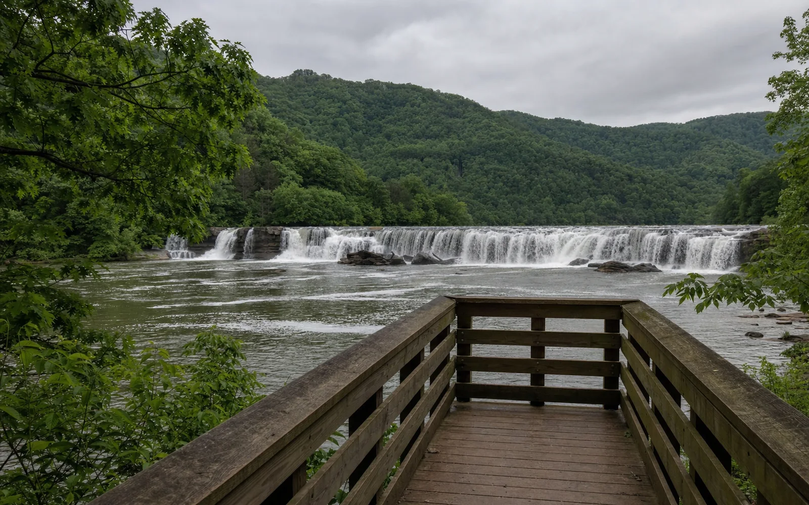 The end of the Sandstone Falls boardwalk, with the wide, low falls stretching across the New River between wooded islands, AI-generated illustration