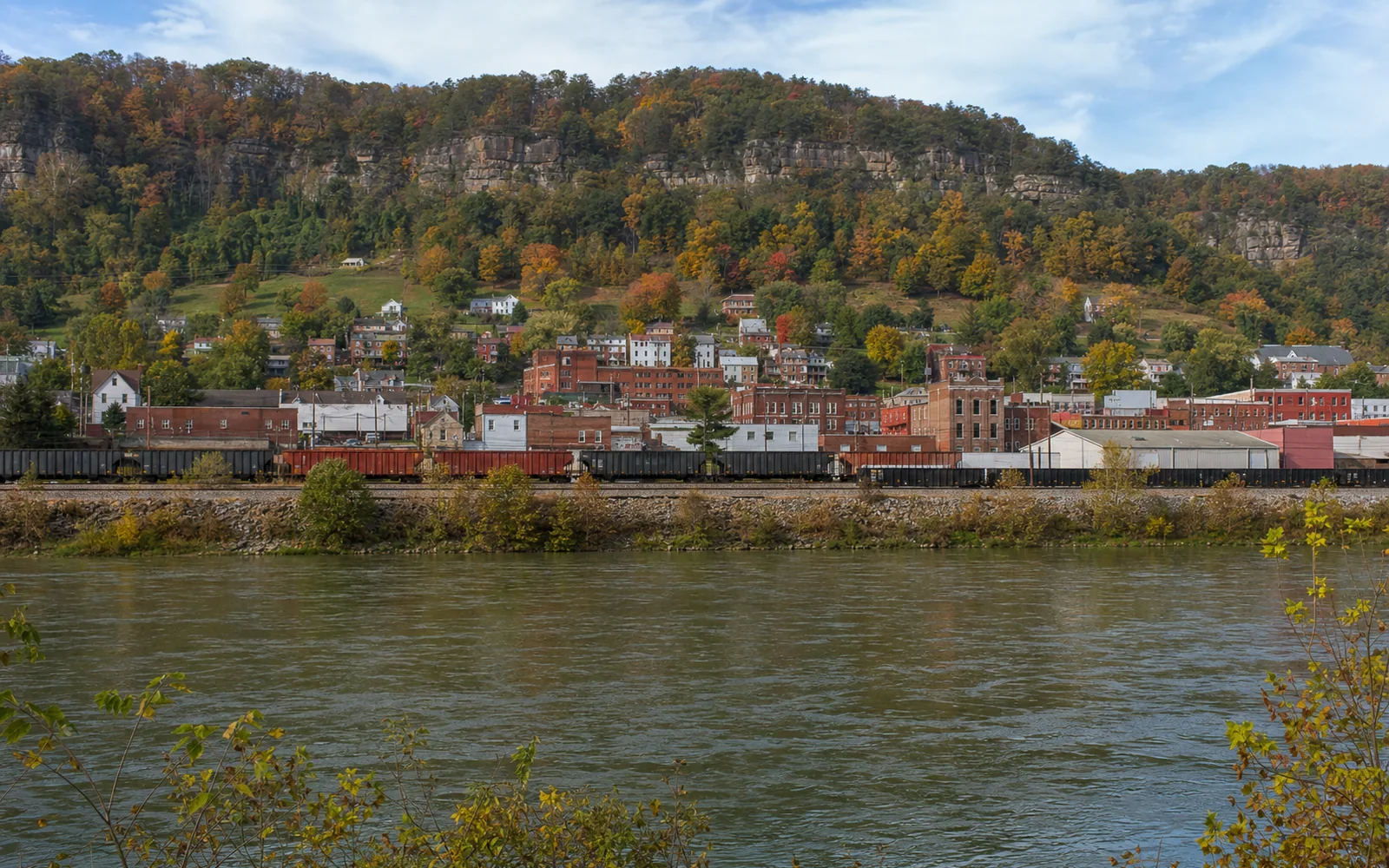 Hinton's brick downtown climbing the hill above the New River, with the rail yard along the water, AI-generated illustration