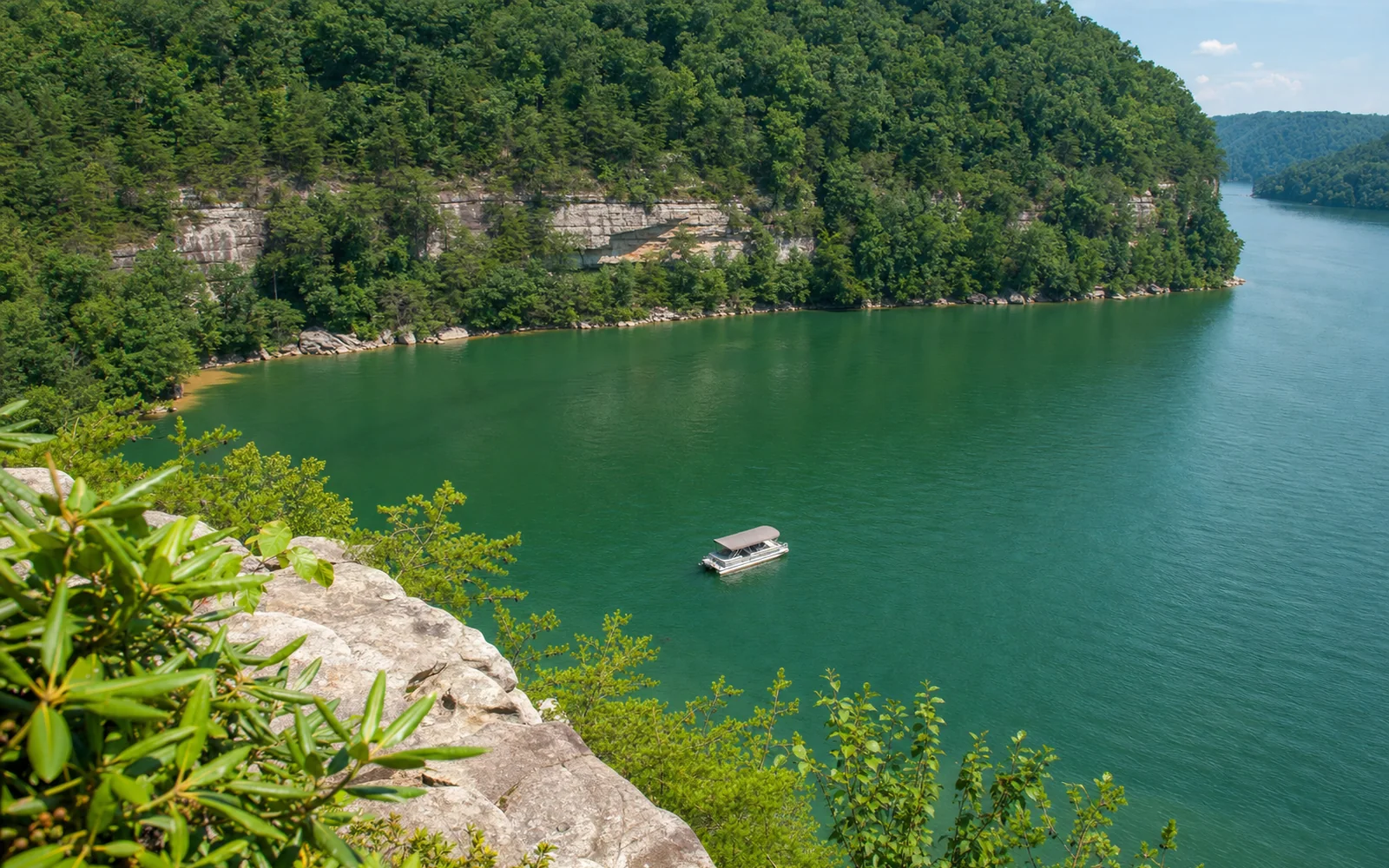 Summersville Lake's clear green water below pale sandstone cliffs, with a pontoon boat and forested shoreline, AI-generated illustration