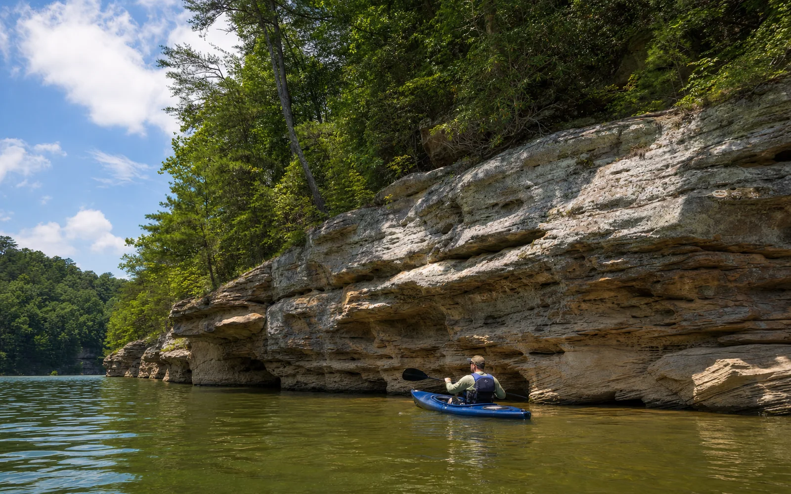 Pale sandstone cliffs meeting clear green water at Summersville Lake, with a kayaker below and forest above, AI-generated illustration