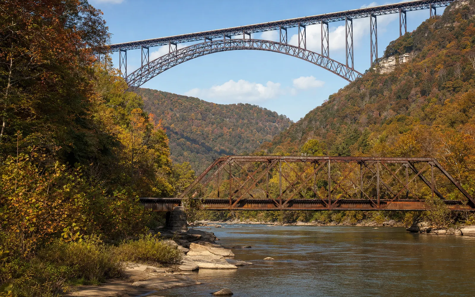 The one-lane Tunney Hunsaker truss bridge at river level in autumn with the steel arch of the New River Gorge Bridge high behind it, AI-generated illustration