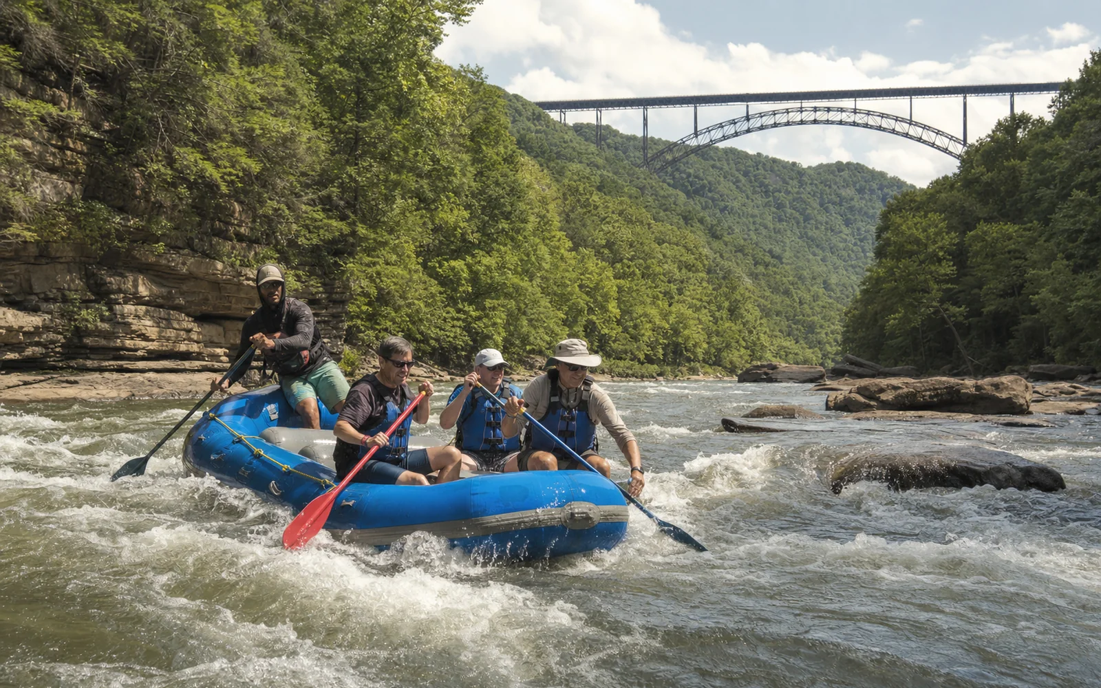 A blue raft with three adult paddlers and a guide at the stern runs a splashy rapid on the New River below sandstone ledges and wooded slopes, with the New River Gorge Bridge arch in the distance, AI-generated illustration